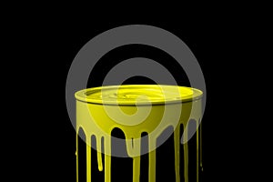 Yellow oil paint flowing down on wall of metal bucket. Isolated