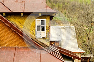 Yellow old fashioned wooden building with white window and with