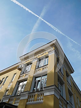 Yellow old house on a sky background bottom view  cityscape