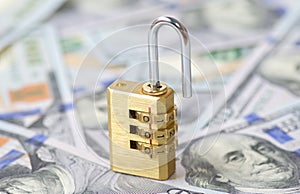 Yellow opened padlock and dollars