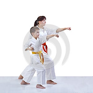 With yellow and orange belt the mother and son are hitting a punch arm