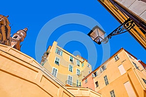 Yellow and orange buildings under blue sky in Menton.