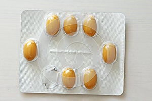 Yellow or orange capsule pill medicine on white background. Pharmaceuticals antibiotics pills medicine