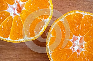 Bright and yellow orange.two halves of tangerine