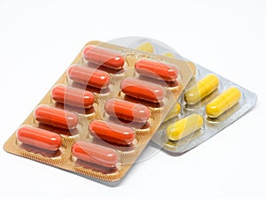 Yellow and orange gelatin capsules pills in blister pack