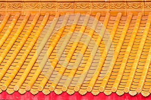 Yellow orange glazed terracotta  roof tiles of a Chinese temple