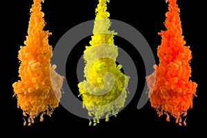 Yellow, orange paint clouds in water isolated on solid black background. Acrylic colors and ink in water. Abstract background. Bri