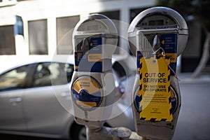 Yellow out of service tag attached on faulty damage of defect car parking metre