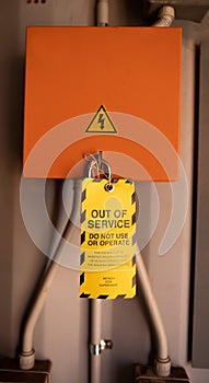 Yellow out of service tag attached on faulty damage defect of contribution power board