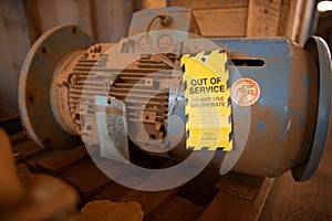 Yellow out of service tag attached on faulty damage defect of electric power motor photo