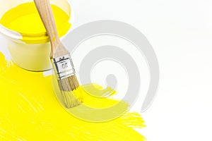 Yellow paint can with paintbrush