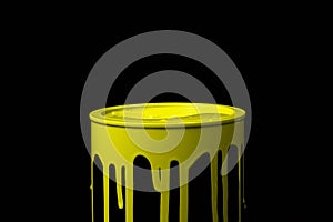 Yellow paint flowing down on wall of metal bucket. Isolated over black