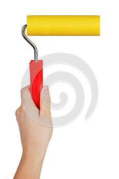 Yellow paint roller in hand