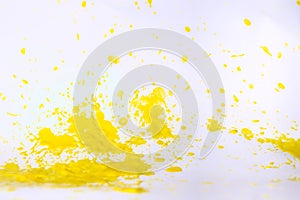 Yellow paint splat on a white back ground.