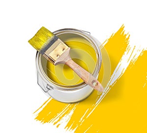 Yellow paint tin can with brush