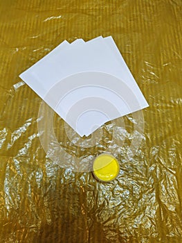 Yellow paint and white papers on oilcloth photo