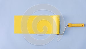 Yellow painted banner with paint roller and copyspace