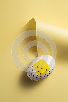 Yellow painted easter egg on yellow background