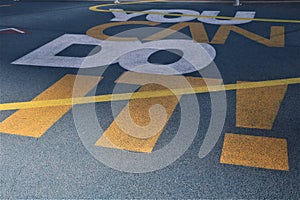 the yellow painted lines on the ground at an airport is visible