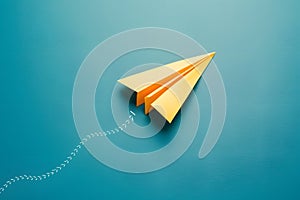 Yellow paper airplane turning on blue background, business direction concept