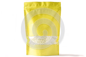 Yellow paper blank doy pack bio pouch with window zipper on white background filled with rice