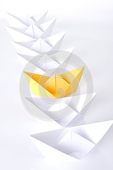 Yellow paper boat in queue