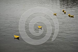 yellow paper boats on the water