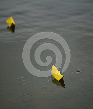 Yellow paper boats on the water