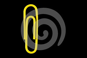 Yellow Paper Clip Isolated on a Black Background