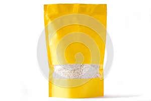 Yellow paper doypack stand up bio pouch with window zipper on white background filled with rice