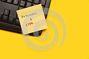 Yellow paper note with password word and 1 2 3 4 numbers on a black computer keyboard on a yellow background