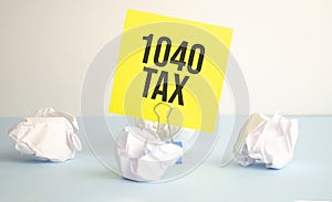 Yellow Paper Note With Words 1040 tax , Tax concept