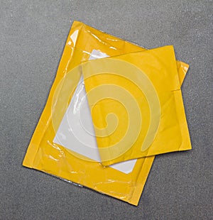 Yellow paper package from Chinese online stores on grey background
