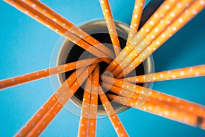 Yellow paper straws isolated on blue background