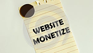 Yellow paper with text Website Monetize on the white fridge