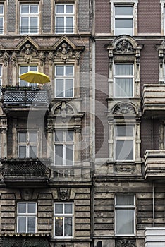 Yellow parasol on a balcony of an old building