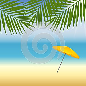 Yellow parasol at the beach under palm trees