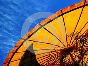 Yellow parasol and blue sky
