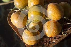 Yellow passion Marquisa fruits. The Bali fruits, Indonesia. Asia fruit in a bowl on the table background