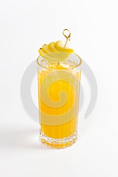 Yellow pear cocktail in a deep glass decorated with a pear and ice