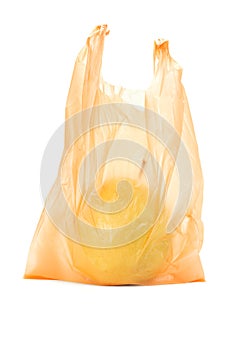 Yellow pear in orange plastic bag