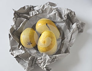 Yellow pears in paper