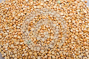Yellow peas for background. The texture of pea groats.