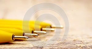 Yellow pen on  wood background