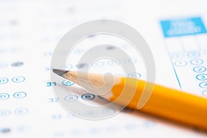 A yellow pencil on a computer read test