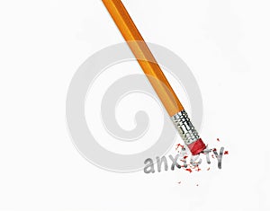 Yellow pencil erasing anxiety text on paper