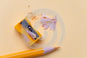 Yellow pencil and metal sharpener on workplace