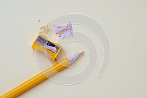 Yellow pencil and metal sharpener on workplace