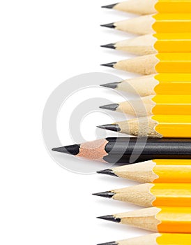 Yellow pencils with one black pencil