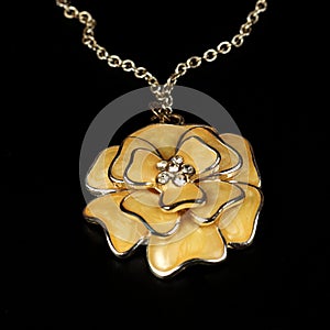 Yellow pendent in the form of a flower, costume jewelry, close up